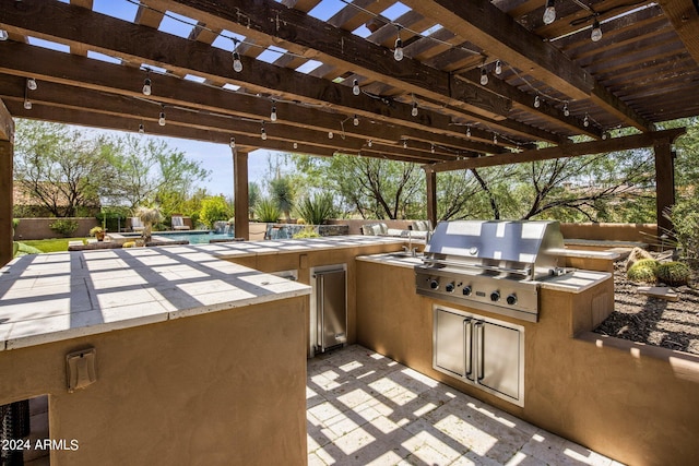 view of patio / terrace with grilling area, an outdoor kitchen, and a pergola