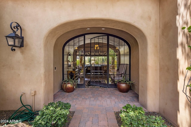 view of exterior entry featuring a patio area