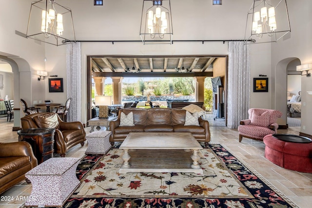 tiled living room featuring an inviting chandelier