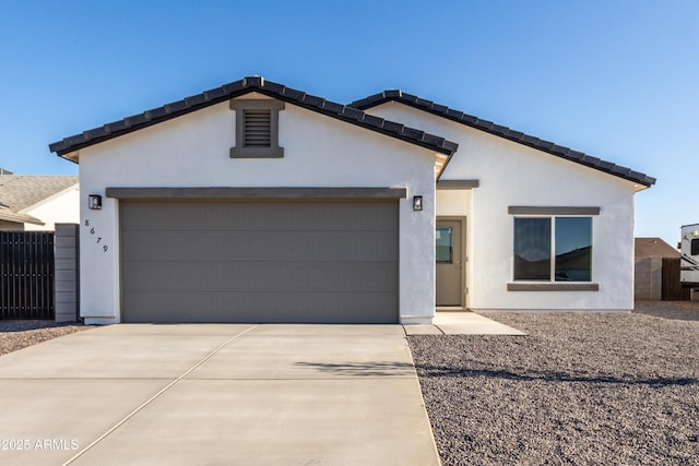 8679 W Raven Dr, Arizona City, AZ 85123 - view of front of house featuring concrete driveway, a garage, and stucco siding