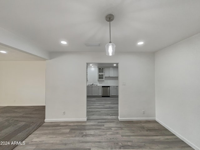 unfurnished room with dark hardwood / wood-style flooring and sink