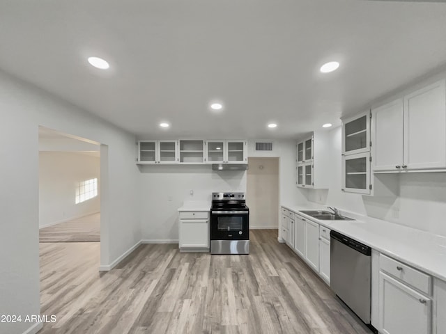 kitchen with white cabinets, light hardwood / wood-style floors, sink, and stainless steel appliances