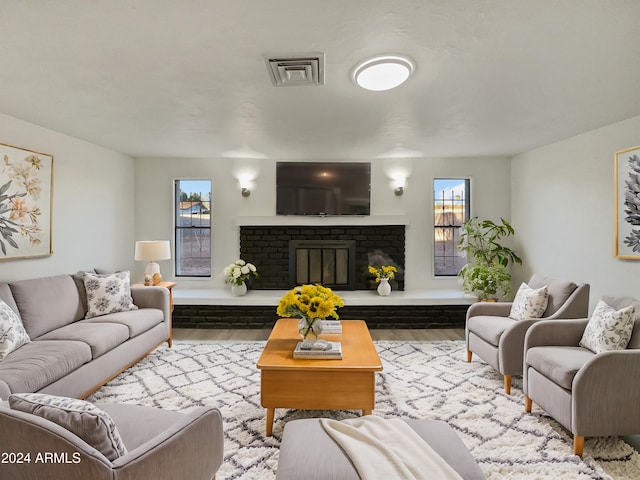 living room with a fireplace and light hardwood / wood-style flooring