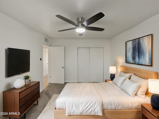 bedroom with ceiling fan, a closet, and carpet