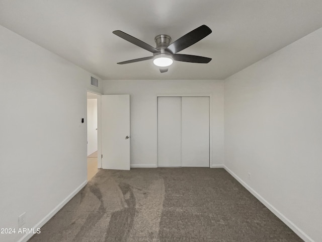 unfurnished bedroom featuring ceiling fan, a closet, and carpet