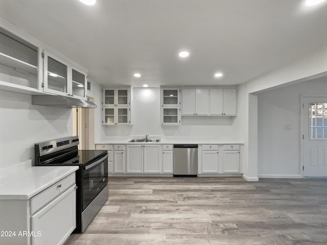 kitchen featuring light hardwood / wood-style floors, white cabinetry, sink, and appliances with stainless steel finishes