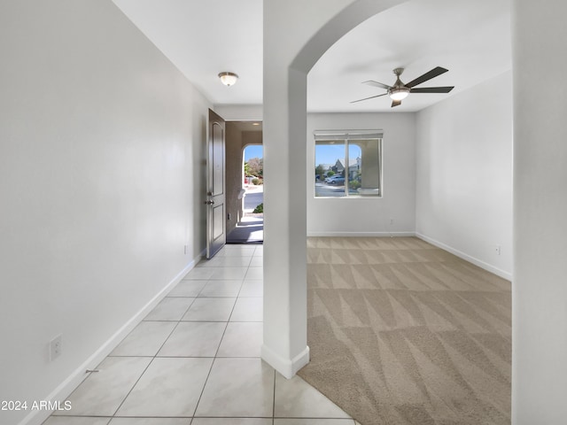 carpeted spare room with ceiling fan