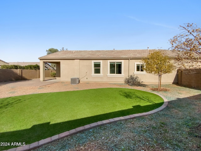 rear view of house with a yard and a patio area