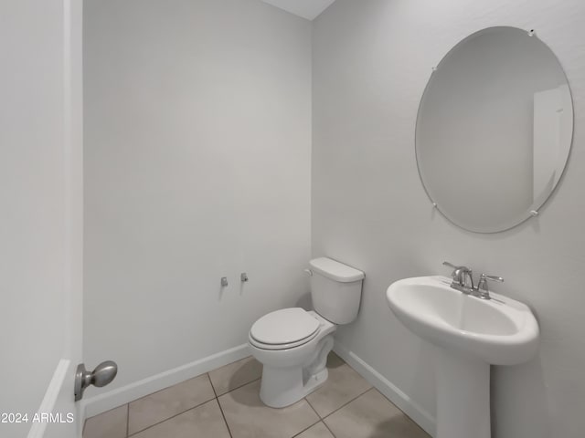 bathroom with toilet and tile patterned floors