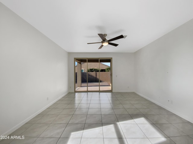 empty room with ceiling fan and light tile patterned floors