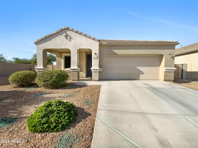 mediterranean / spanish-style house with a porch and a garage