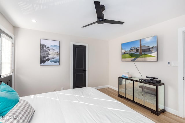 bedroom with ceiling fan and light hardwood / wood-style floors