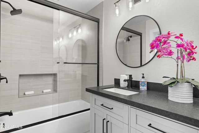 bathroom with vanity and combined bath / shower with glass door