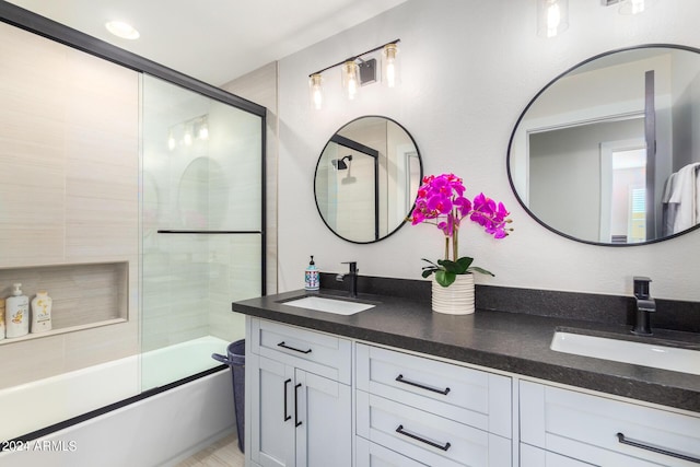 bathroom with shower / bath combination with glass door and vanity