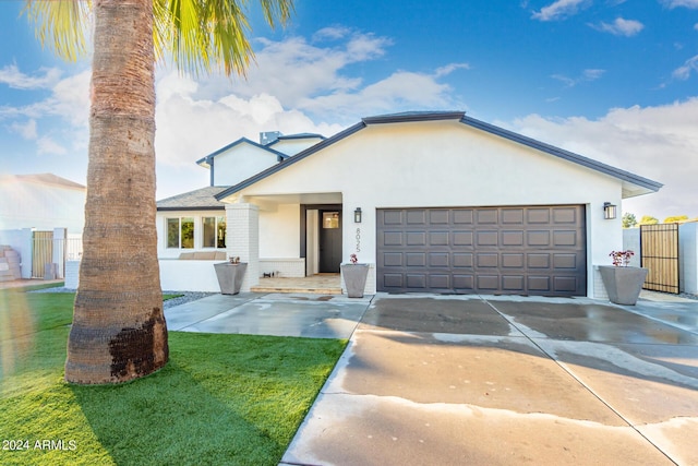 view of front of house featuring a front yard and a garage