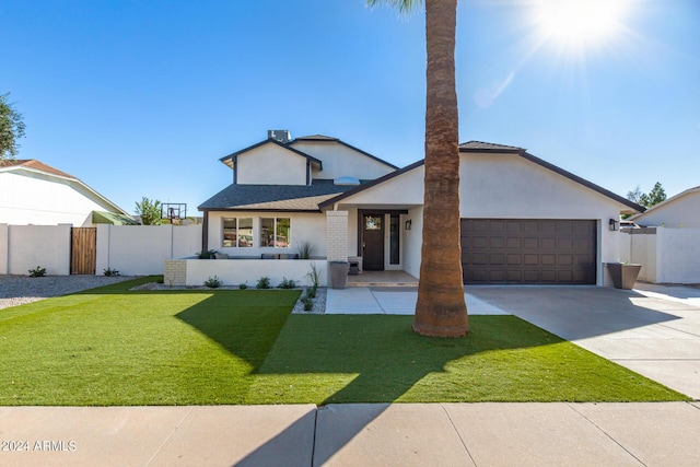 view of front facade featuring a garage and a front yard