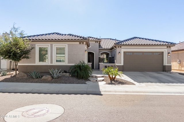 mediterranean / spanish-style home with a garage