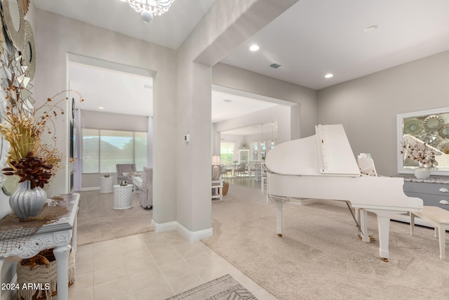 interior space featuring a chandelier, a wealth of natural light, and light colored carpet