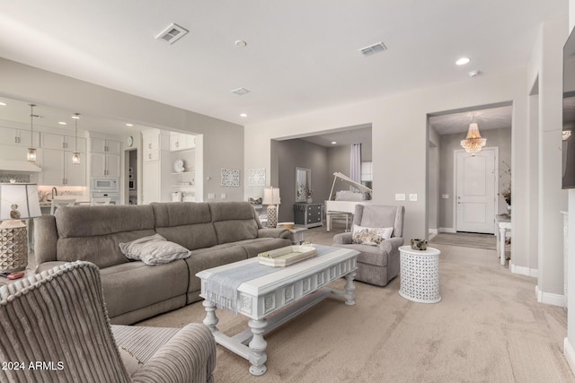 carpeted living room with sink