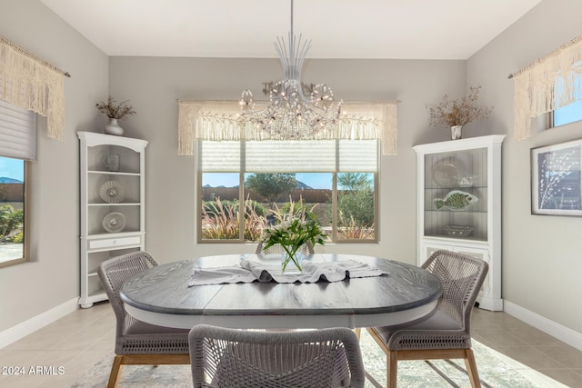 tiled dining area with an inviting chandelier