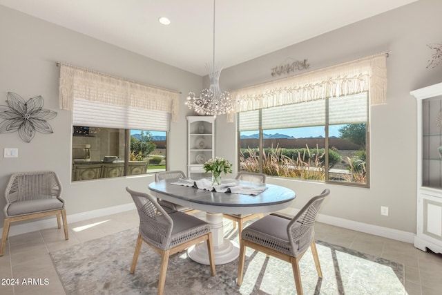 tiled dining area with plenty of natural light and an inviting chandelier