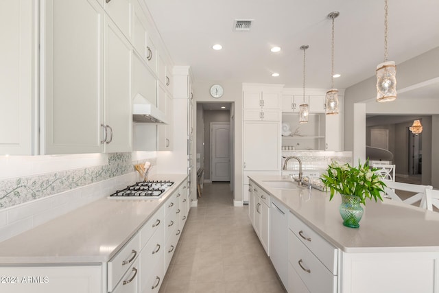 kitchen featuring a large island with sink, white cabinetry, sink, and white appliances