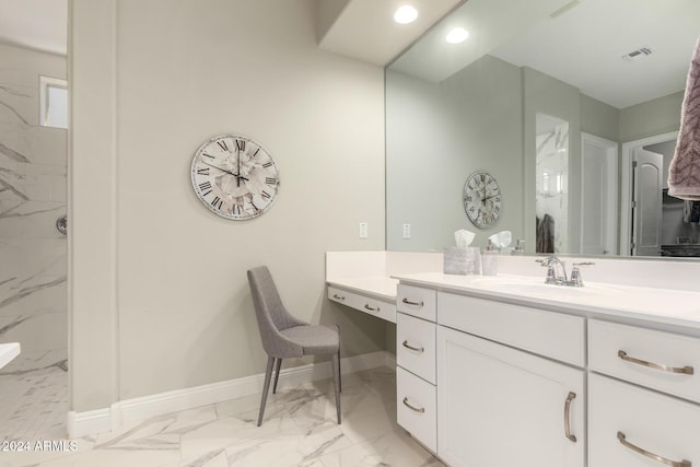 bathroom with vanity and tiled shower