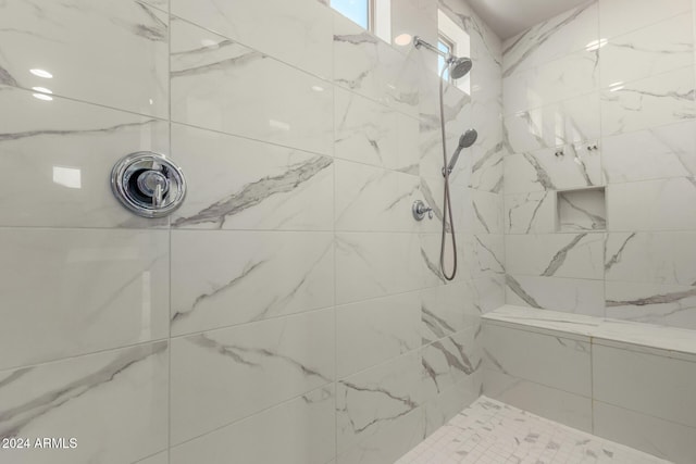 bathroom featuring tiled shower