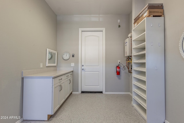 spacious closet featuring tankless water heater