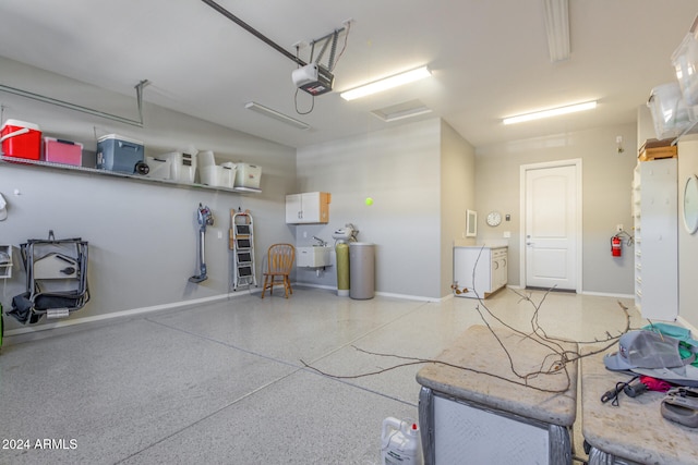 garage featuring sink and a garage door opener