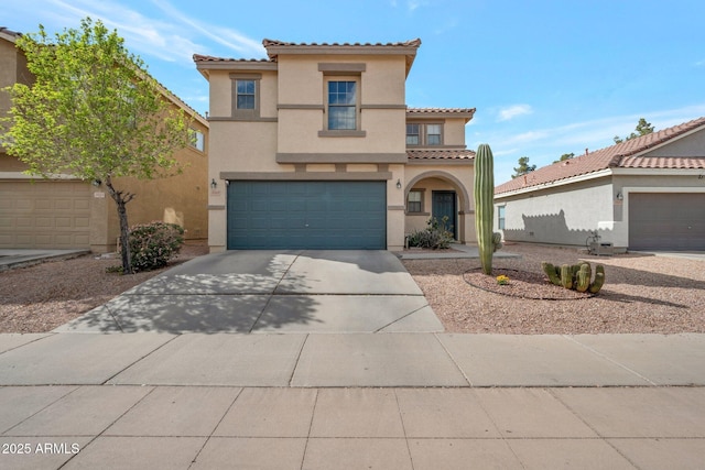 mediterranean / spanish-style home featuring a garage, driveway, a tiled roof, and stucco siding