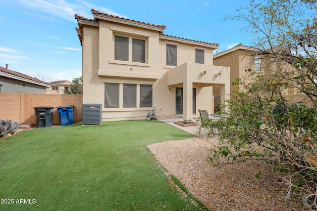 back of property featuring a patio, a tile roof, fence, a yard, and stucco siding