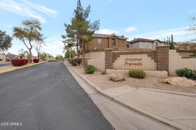 view of road with curbs, sidewalks, and a residential view