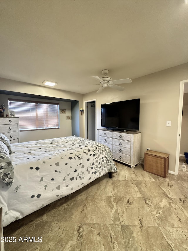 bedroom featuring a ceiling fan and baseboards