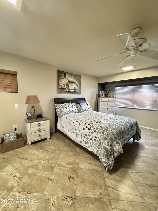 bedroom with baseboards and a ceiling fan