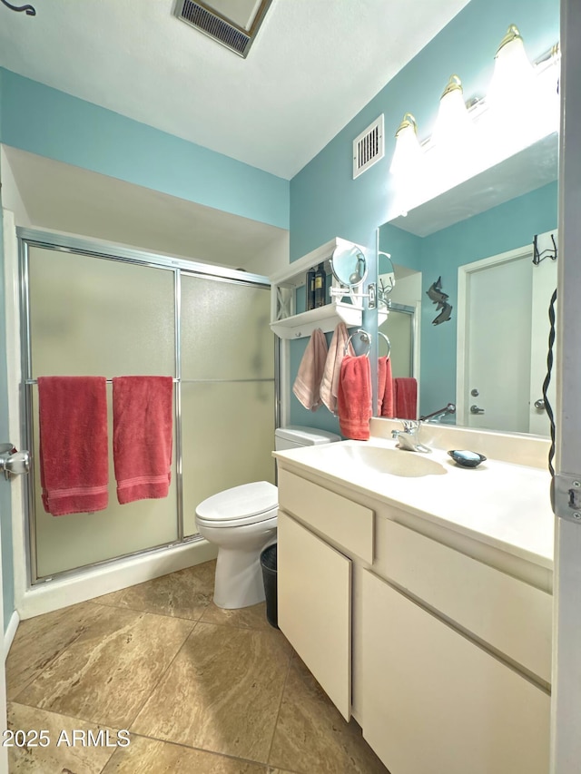 bathroom with toilet, a stall shower, visible vents, and vanity