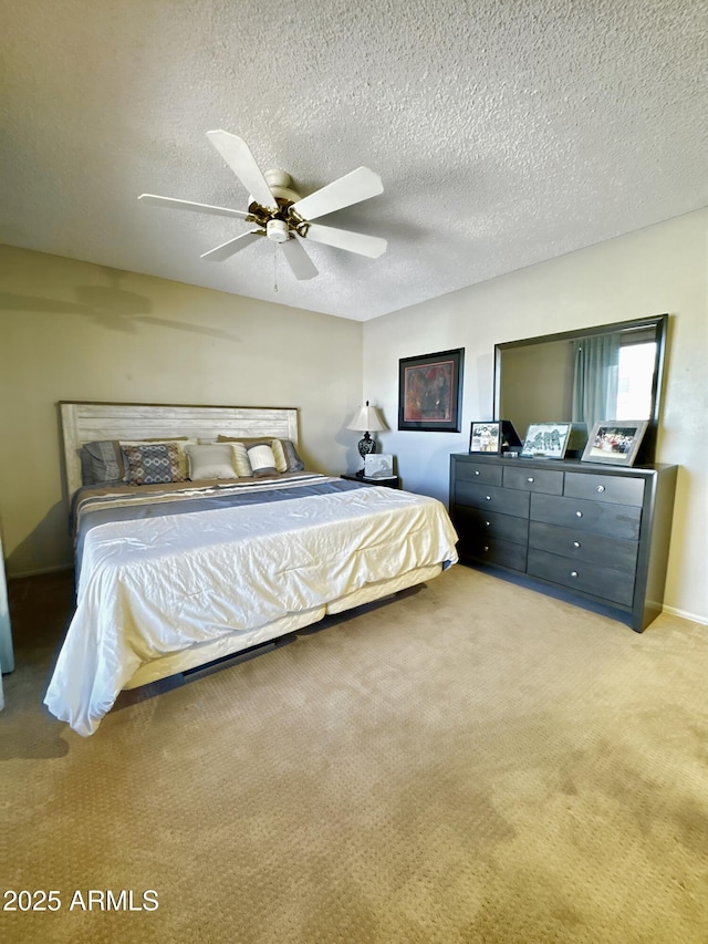 carpeted bedroom featuring a ceiling fan and a textured ceiling