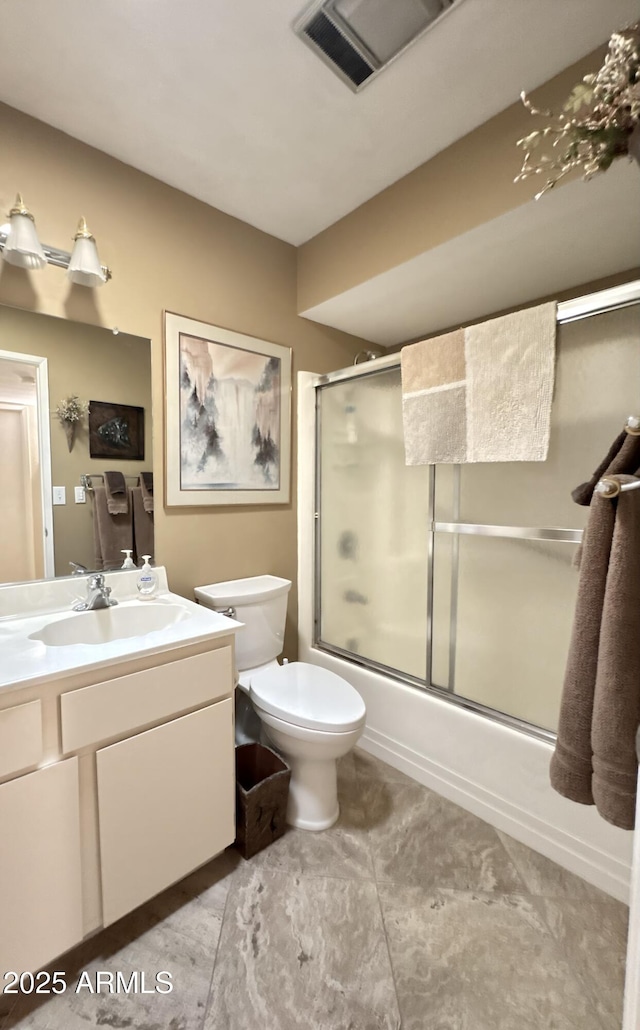 bathroom featuring enclosed tub / shower combo, toilet, visible vents, and vanity