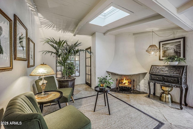 living area featuring a large fireplace, beam ceiling, and a skylight