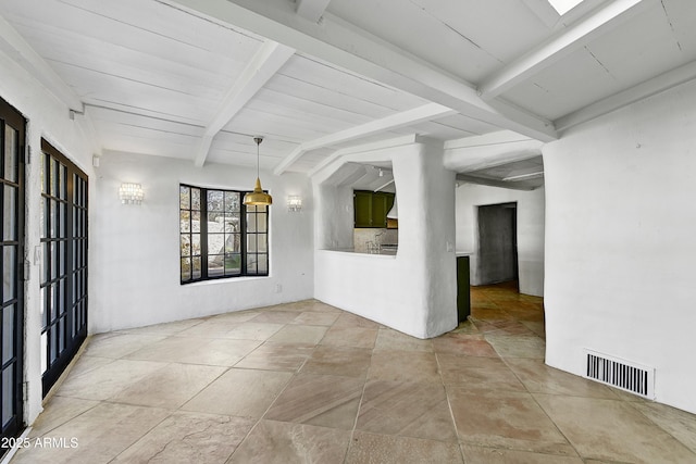 spare room featuring lofted ceiling with beams