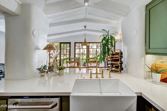 kitchen featuring vaulted ceiling, decorative light fixtures, stainless steel dishwasher, and green cabinetry