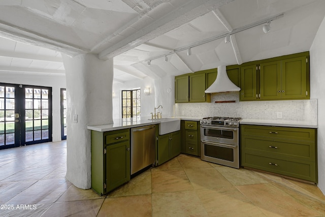 kitchen featuring a healthy amount of sunlight, appliances with stainless steel finishes, sink, and french doors