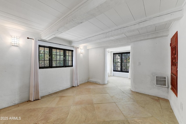 empty room with beamed ceiling