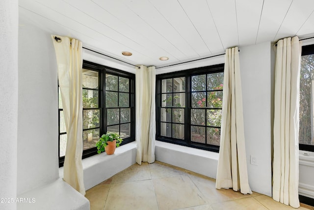 unfurnished sunroom with plenty of natural light