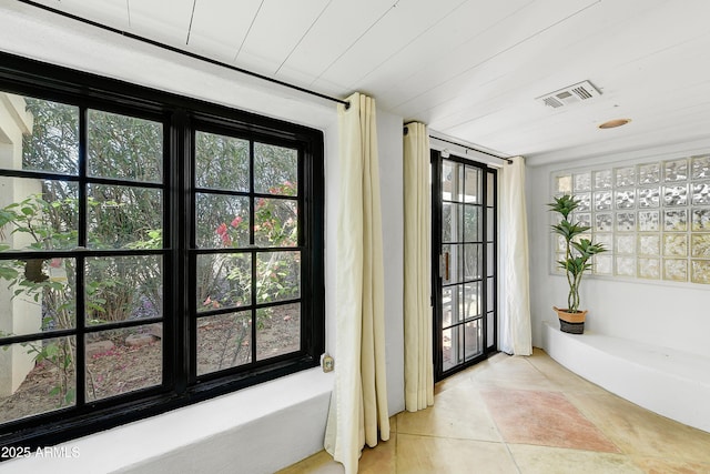 entryway featuring light tile patterned floors and wood ceiling