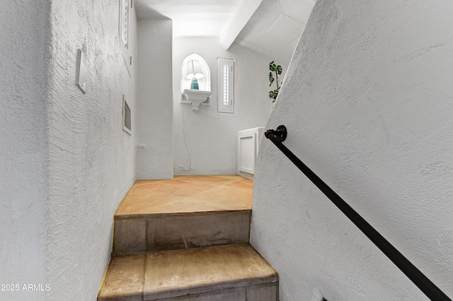 stairs featuring vaulted ceiling