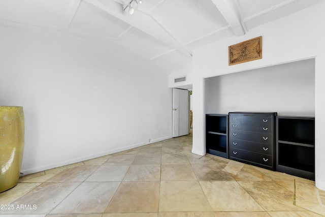 unfurnished bedroom featuring vaulted ceiling with beams and light tile patterned floors