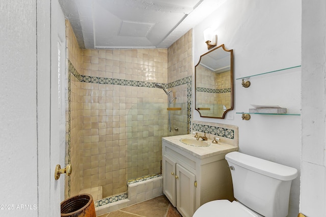 bathroom with vanity, tiled shower, and toilet