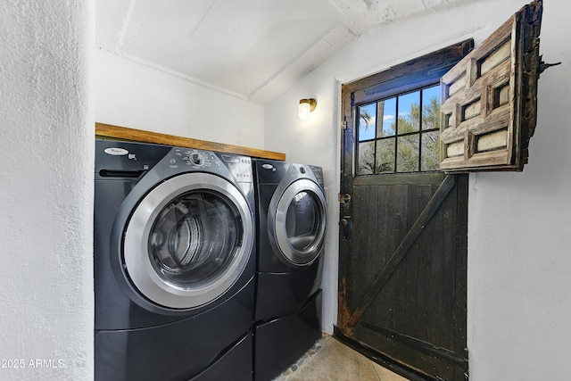 clothes washing area with washing machine and dryer