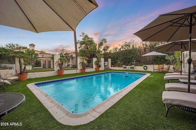 pool at dusk with a yard